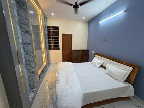 a bedroom with a bed with a stone wall at Divine House in Lucknow