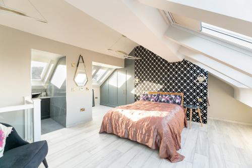 a bedroom with a bed and a wall with windows at The Grand Weave House in Shipley