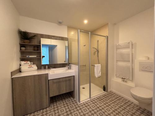 a bathroom with a shower and a sink and a toilet at DOMITYS - Villa Caron - AEROPORT ORLY in Athis-Mons