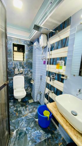 a bathroom with a toilet and a sink at Kalpataru Hometel in Mumbai