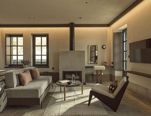 a living room with a couch and a fireplace at Oreno Mountain Retreat Hotel in Tsepelovo