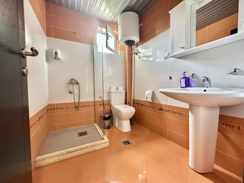 a bathroom with a shower and a sink and a toilet at WEST GATE free parking & wi-fi in Sutomore