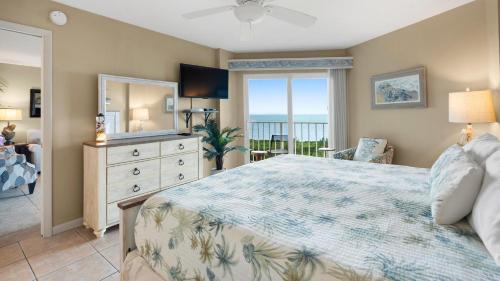 a bedroom with a bed and a view of the ocean at 4409 Ocean Pointe Suites in Tavernier