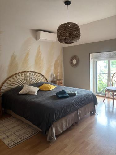 a bedroom with a large bed in a room at Maison d’izier in Izier