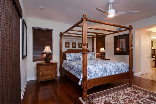 a bedroom with a canopy bed with a wooden frame at 515 Mariners Club in Key Largo