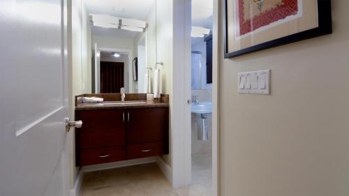 a bathroom with a sink and a mirror at 515 Mariners Club in Key Largo