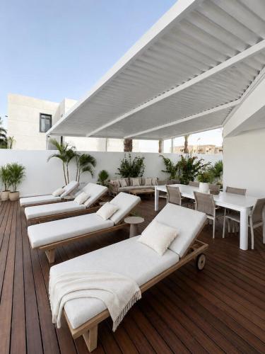 a row of chaise lounges on a deck at Villa Gardenya וילה גרדניה אילת in Eilat