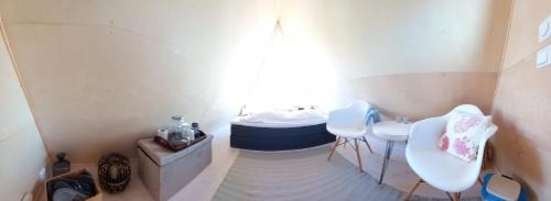a small bathroom with a sink and a tub at Glamping hut with panorama view in Björköby
