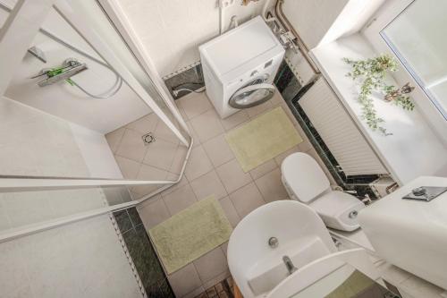 a small bathroom with a toilet and a sink at Leonardo Vila Centre in Palanga