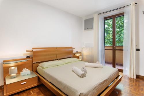 a bedroom with a bed and a large window at Villa In Saronno in Saronno