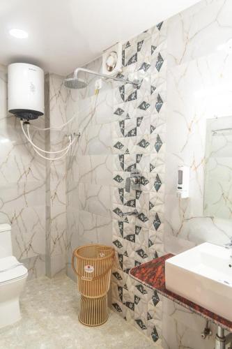 a bathroom with a sink and a toilet at Raghuvansh Hotel in Gaya