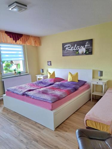 a bedroom with a large bed with purple sheets at Ferienwohnung Familie Windt in Feldberg