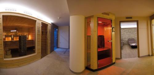 a hallway with a room with a large mirror and a room with at Hotel Eichenhof in Tirolo