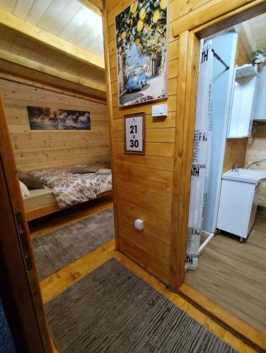 a room with a bed and a door with a sign at Brvnara Nido in Cetinje