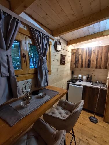 a kitchen with a table and chairs in a cabin at Brvnara Nido in Cetinje