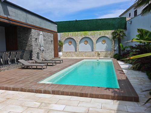 a swimming pool in a yard with a patio at Sunnyside cottage Bilgah in Bilgah