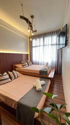 a hotel room with two beds and a window at Speranza Hotel & Restaurant in Infanta