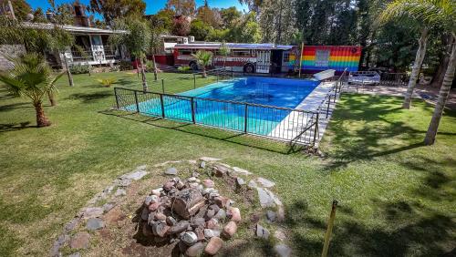 a swimming pool with a fire truck in a yard at Hostel Lemon Tree in Ciudad Lujan de Cuyo