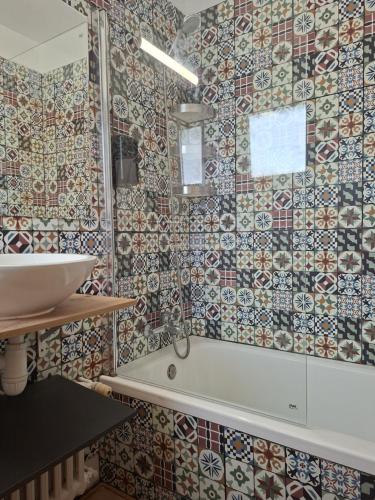 a bathroom with a tub and a sink at Hotel 139 in Castelldefels