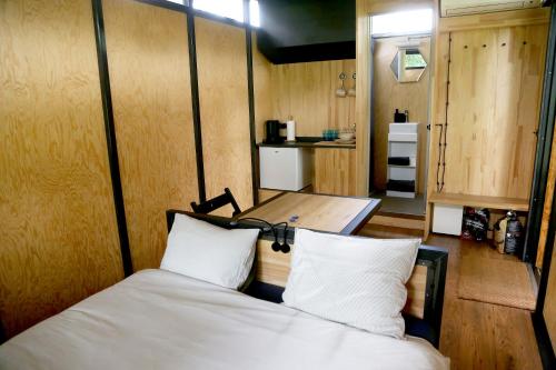 a bedroom with a bed with white pillows at IRON Cabin in Gaylyunay