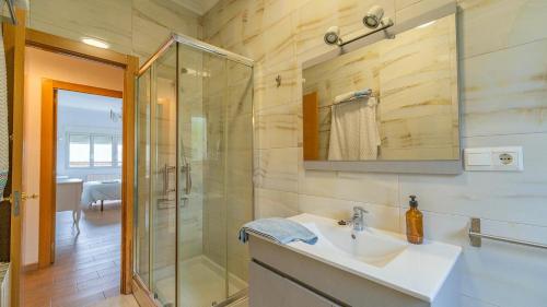 a bathroom with a sink and a glass shower at Monte la Torre in Santander