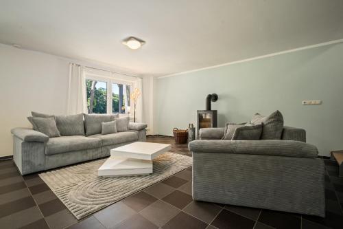 a living room with two couches and a coffee table at Ferienhaus Träumerei am Plauer See in Alt Schwerin