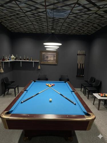a ping pong table in a room with a pool at Beloved Regency Homestay in Kandy