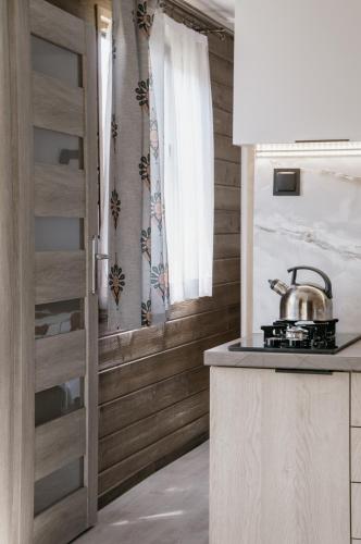 a kitchen with a tea kettle on a stove at U Bochniaka in Czorsztyn