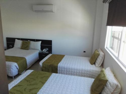a hotel room with two beds and a window at Gran Hotel Internacional Sanbara in Arauca