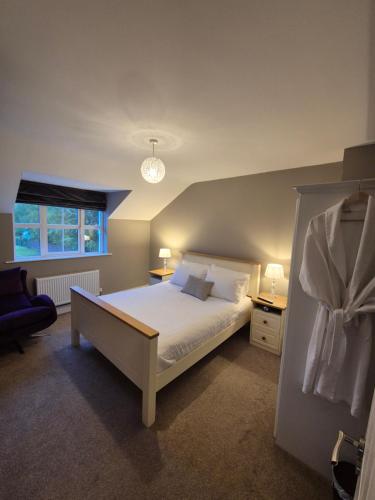 a bedroom with a large bed and a window at Central House Kenmare in Kenmare