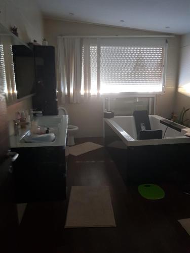 a bathroom with a bath tub and a sink at le jasmin in El Achour