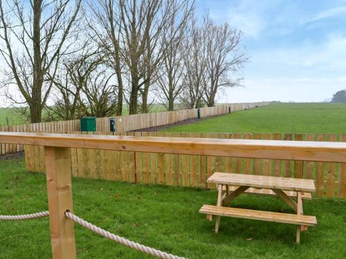 a wooden bench next to a wooden fence at The Rams Rest - Uk48823 in Kirby Misperton