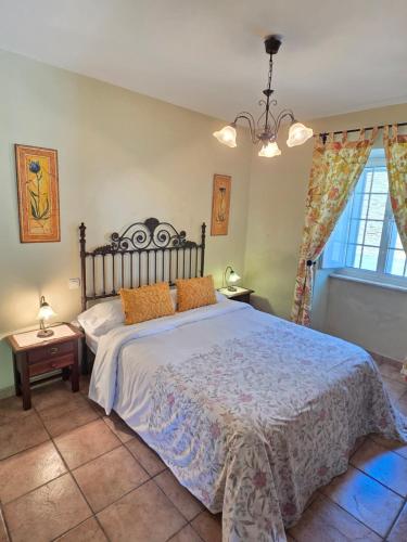 a bedroom with a large bed and a window at Apartamentos Turísticos Rosa in Ribadeo