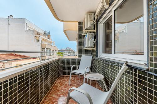 a balcony with two chairs and a window at Sunrise Arts 2 in Torrevieja