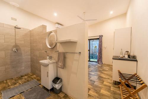 a bathroom with a toilet and a sink and a shower at Wild Villas in Victoria Falls