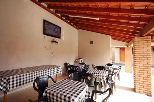 a room with tables and chairs and a basketball hoop at Pousada Facincani in Olímpia
