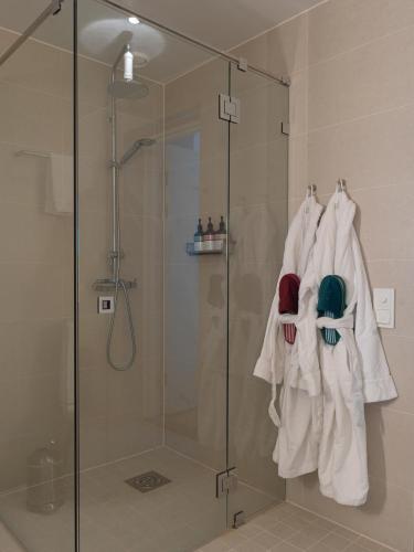 a shower with a glass shower stall with towels at Elite Hotel Ideon, Lund in Lund