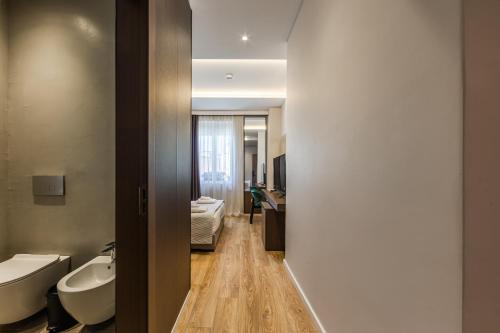 a bathroom with two sinks and two toilets at Hotel Aquila D in Durrës