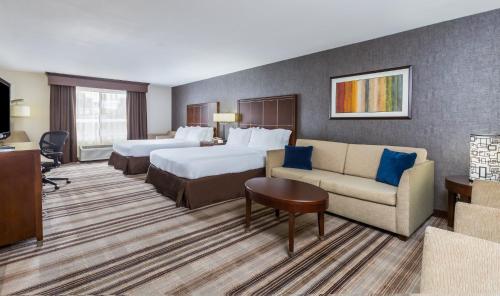 a hotel room with two beds and a couch at Holiday Inn Express San Diego - Sea World Area by IHG in San Diego