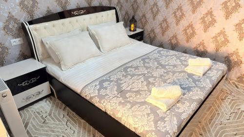 a small bed in a room with at Private 3BR House 2 Min Walk to Registan in Samarkand