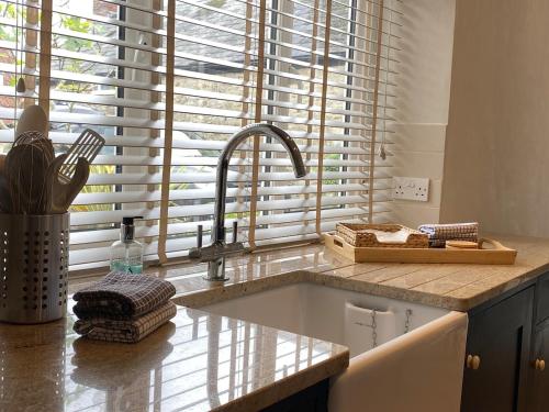 a kitchen counter with a sink and a window at Hidden Gem - Charmouth Dorset in Charmouth