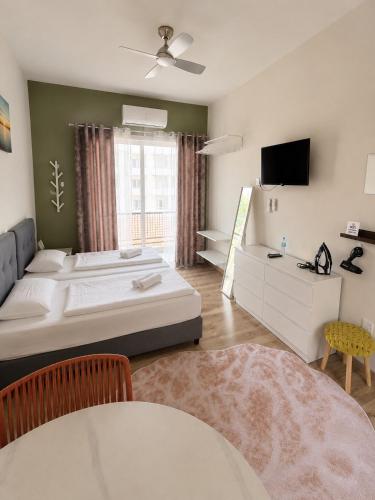 a bedroom with a large bed and a television at Smart Deluxe Studio N9 private Kitchenette Balcony Beach 250m Marina Port 900m in Limassol