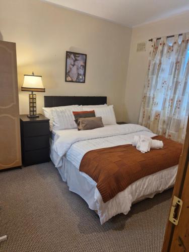 a bedroom with a large bed and a lamp at Bellmullet, Waterside Townhouse in Belmullet