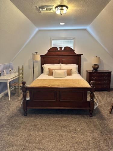 a bedroom with a bed with a wooden head board at Deluxe Farm Studio Apt with Pool View in Alachua