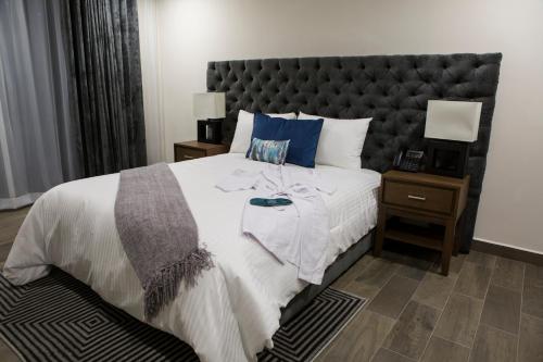 a bedroom with a large bed with a large headboard at Suites Rio Elba in Mexico City