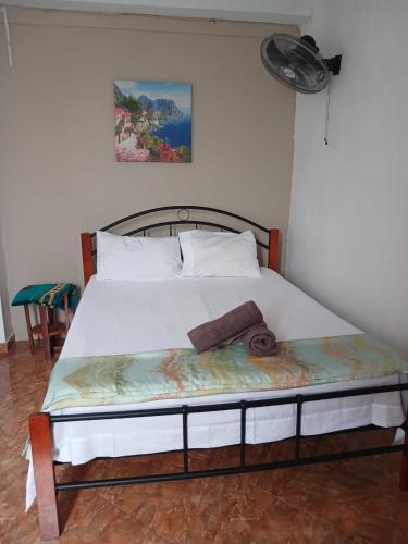a bedroom with a bed with a white bedspread at Green Peak Stay in Port Louis