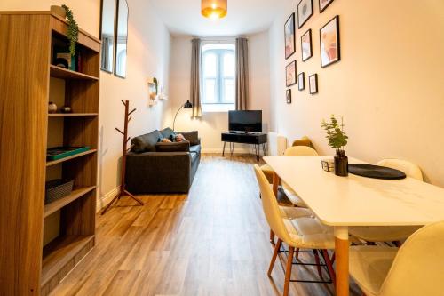 a living room with a table and a dining room at Chapel Retreat | King Bed | Central Swansea in Swansea