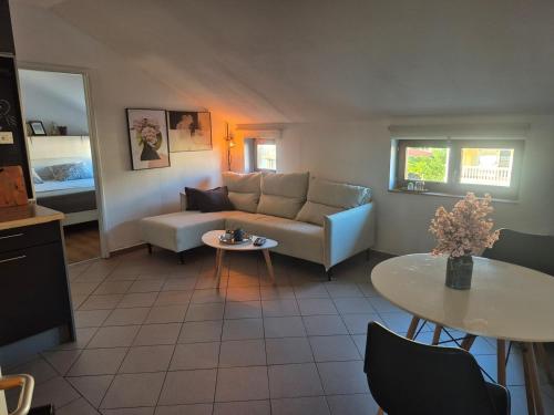 a living room with a couch and a table at Apartment Vdovjak in Malinska
