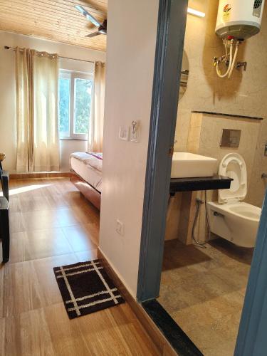 a bathroom with a sink and a toilet in a room at Saadhan Homestay in Mussoorie