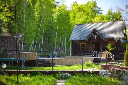 a log cabin with a playground in front of it at El Rancho De Stayki in Stayki